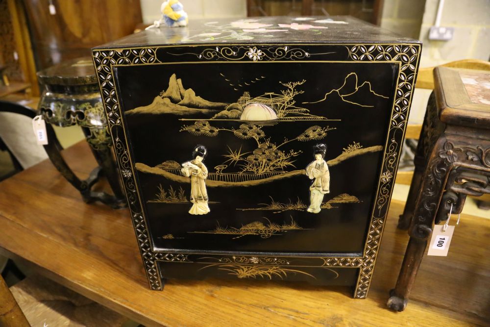 A Chinese black-lacquered brass-mounted small two-door cabinet, the door panels decorated with figures, width 51cm, depth 51cm, height